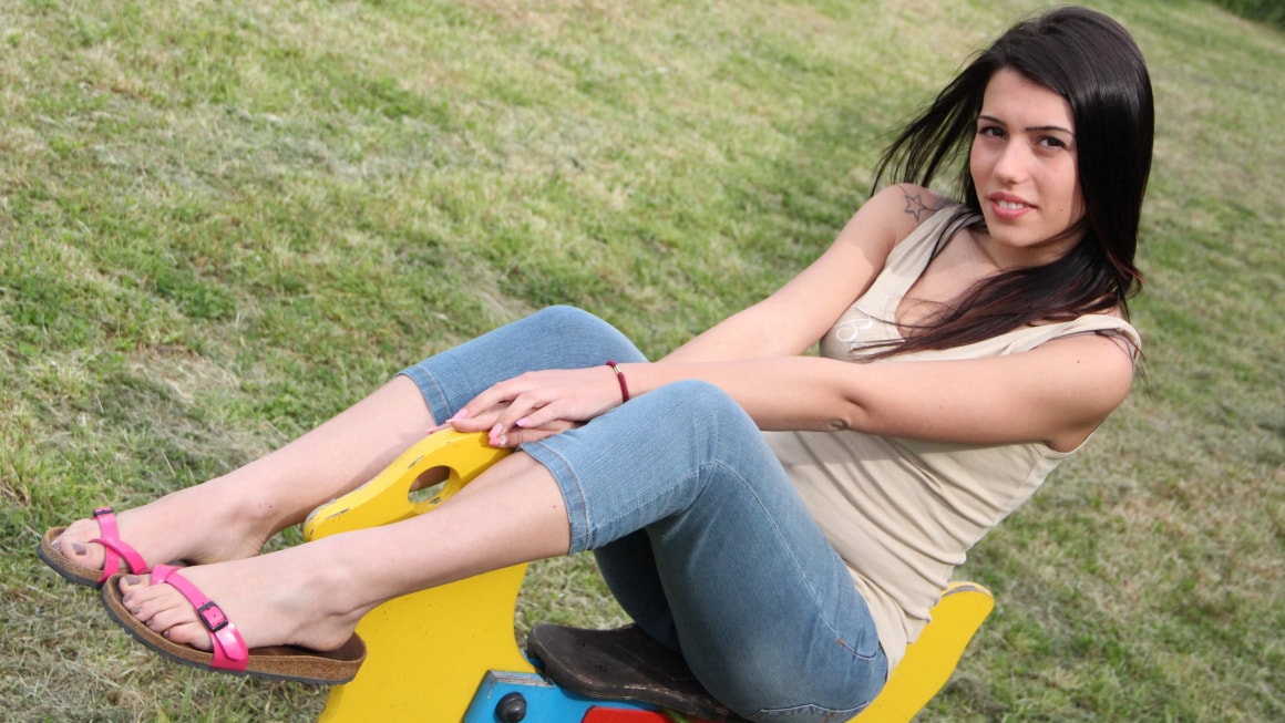 Lovely Petra In A PlayGround Riding A Wooden Horse Bare Foot